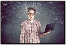 Photo of a guy holding a laptop with a confused look on his face