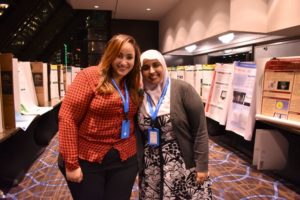 Reham and Sana standing in the poster area