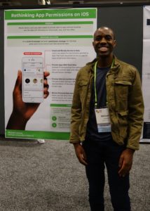 Michael standing next to his SRC poster at CHI 2018