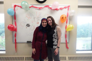Hala and Sonia standing with decorated whiteboard