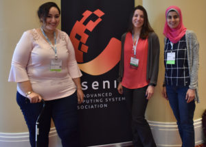 Reham, Sonia, and Hala standing next to the USENIX banner at SOUPS 2018