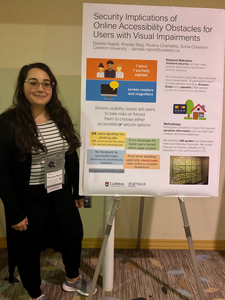 Daniela standing next to her poster at SOUPS 2019