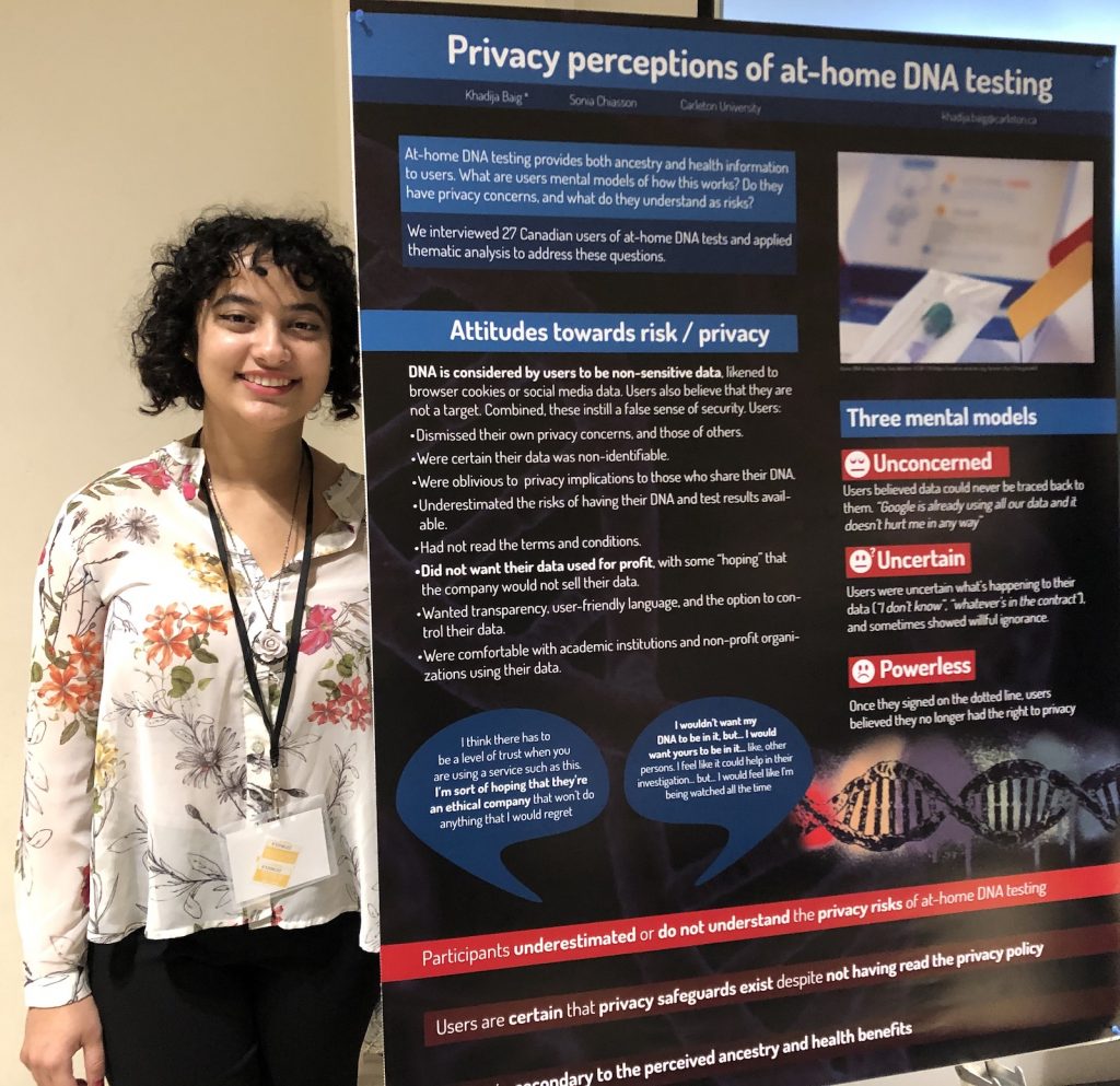 Khadija stands next to her poster on Privacy Perceptions of at-home DNA testing at the 2019 SERENE-RISC conference