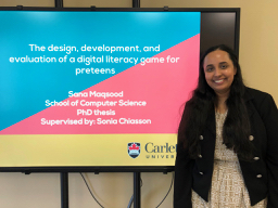 Sana Maqsood standing next to her PhD Defence title slide