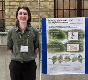Max standing next to his poster at COMPASS 2025